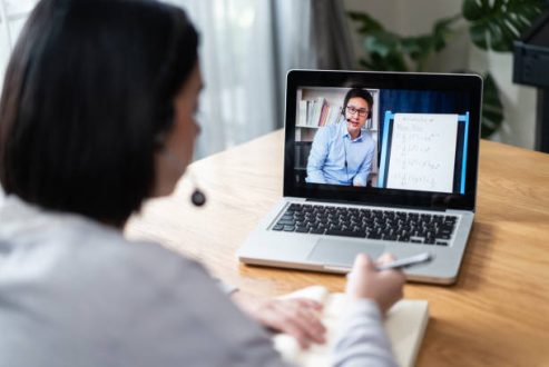 Homeschool Caucasian cute young girl student learning virtual internet online class from school teacher by remote meeting due to covid pandemic. Male teacher teaching math calculus by using whiteboard